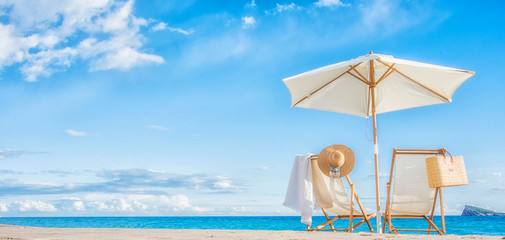 Two beach chairs at the sea background