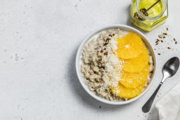 Vanilla citrus coconut overnight oatmeal. Top view, copy space.