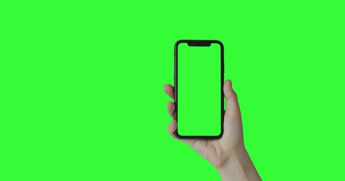 Woman Hand Holding The Smartphone On Green Screen Chroma Key Background.  Mobile Phone Mock-up For Your Product. The IPhone Xr Model In Vertical Orientation Portrait Mode. USA, California