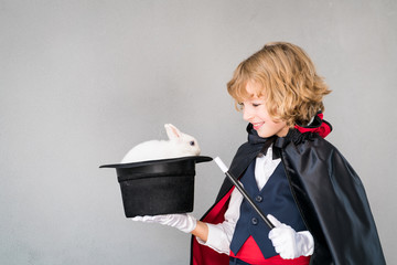 Child illusionist with cute rabbit