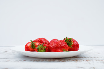 red strawberries on a white plate