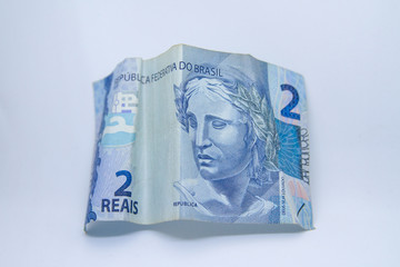 Two reais banknote (Brazilian currency) on a white background