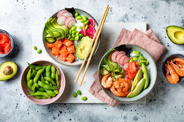 Hawaiian salmon and shrimp poke bowl with seaweed, avocado, watermelon radish, edamame and...