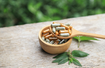 herbal medicine in wooden bowl for healthy eating  with green herb 