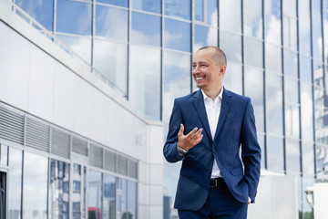 Business man near a large modern glass building