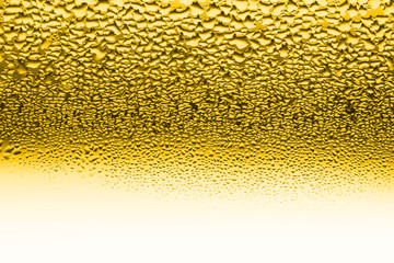 Water drops on the wet glass. Abstract honey background. Yellow color.