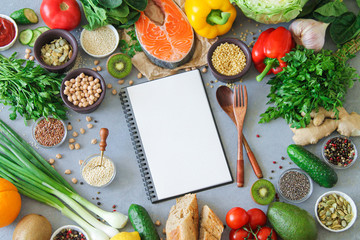 Healthy uncooked food frame background with copy space in blank notepad and keto diet and meal plan...