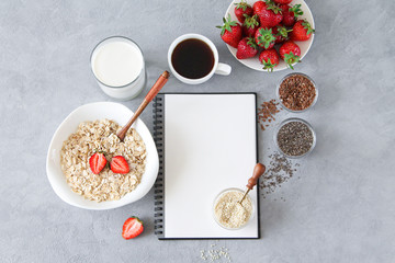 Delicious and healthy breakfast ingredients: oatmeal, milk, seeds, strawberries. Balanced diet and food recipe concept