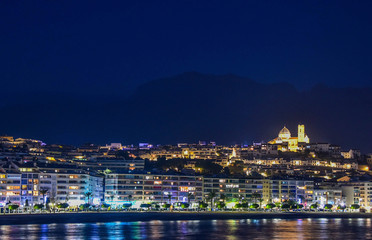 Fototapeta premium Night city by the sea with an empty beach and beautiful night lighting, Summer background