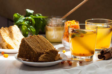 Tea with sea buckthorn, mint, honey, cinnamon, honey layered cake medovik.