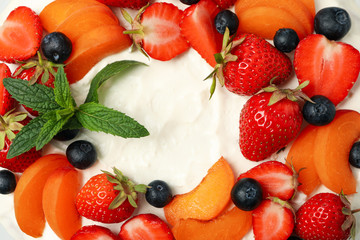 Berry cream cake on whole background, close up. Delicious dessert