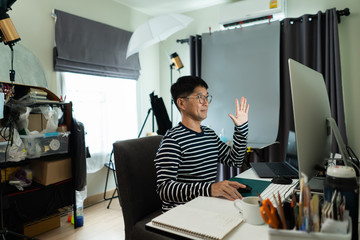 Asian man working at home for self quarantine against COVID-19 pandemic.