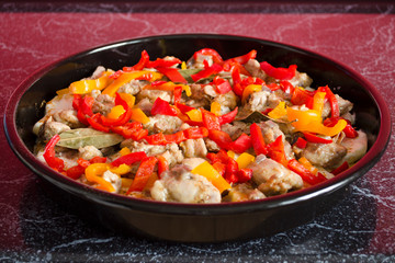 Meat casserole with vegetables close-up. Cooking process. Homemade side dish in the oven pan. 