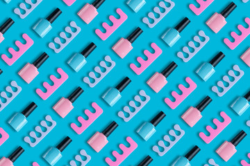 Bright summer pattern on the theme of a trendy pedicure. On a blue background, bottles of blue and pink nail polish and toe separators. Stylish creativity wallpapers for your computer desktop