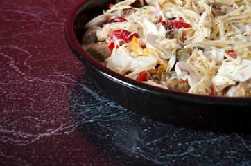 Meat casserole with vegetables and mushrooms close-up. Cooking process. Homemade stew in the pan with copy space.