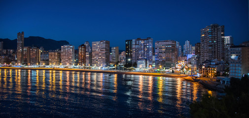 Fototapeta na wymiar Night city by the sea with an empty beach and beautiful night lighting, Summer background