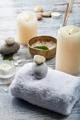 Obraz na płótnie Canvas SPA. Set of stone, towel, vase, incense sticks, candles and vessels with salt.