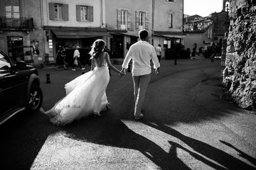 Wedding couple walking around the city. Holding hands.