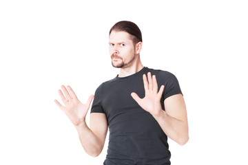 A young man shows a stop gesture. In studio isolated on a white background.