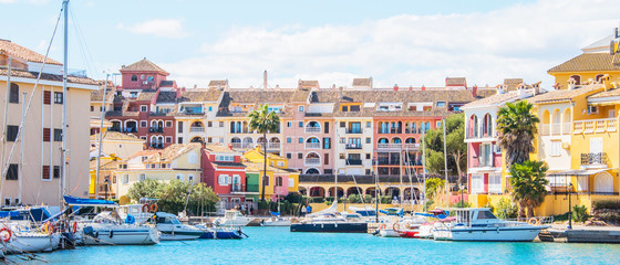 Port Sa Playa, Valencia, Spain - 3/19/2019: Bright sunny day photo looking at Port Saplaya, Valencia's Little Venice - obrazy, fototapety, plakaty
