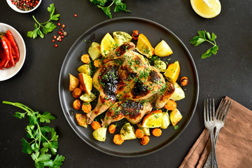Spatchcocked grilled chicken with vegetables on plate