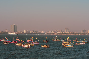 Fototapeta na wymiar Fishing Boats at Worli Fort - Background the Bandra-Worli Sealink bridge, Mumbai City, Beautiful Sunset, Maharashtra, India