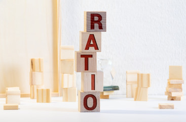 Block of alphabet letters forming the word RATIO on wooden surface. Concept of common marketing business terms. Slightly defocused and close-up shot. Copy space.