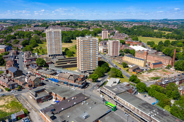 Aerial photo of the town centre of Armley in Leeds West Yorkshire on a bright sunny summers day showing apartment blocks flats and main roads going in to the town © Duncan