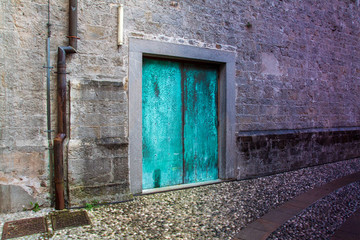 Ancient copper gate with a deep patina