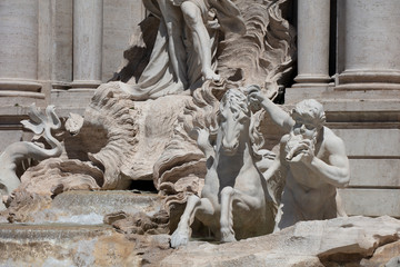 Detail of the statues on the Trevi Fountain in Rome, showing the tritons and sea horses struggling on the rocks.