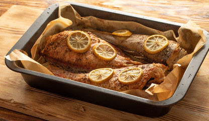 Baked fish in a baking dish close up