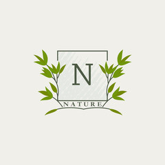 Green eco letters N logo with leaves in square shape. Initials with botanical elements with floral letter design for business identity style