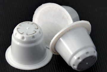 White coffee capsule in black background