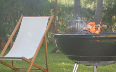 Summertime fun. Barbecue for summer family dinner in the backyard of the house.