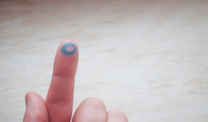 Blue circle on the finger. Symbol of diabetes. World Diabetes Day. Insulin addiction.	