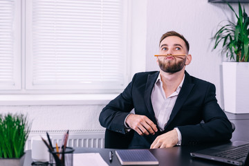 man takes a break from work. Millennial guy having fun making a