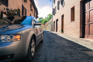 Car parked in one of medieval streets of San Gimignano, Italy