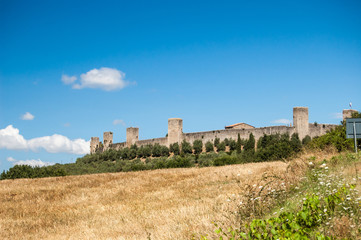Fototapeta na wymiar MONTERIGGIONI, ITALY - AUGUST 20: Medieval Tuscan Fortress used in Assassin's Creed video game on August 20th 2013 in Monteriggioni, Italy.
