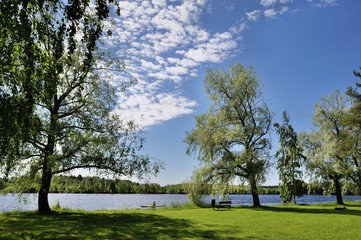Boating in Natural Lake Surrounded by Forest, Grassland and Trees in Joensuu, Northern Karelia, Finland at Summer Morning in July 2019