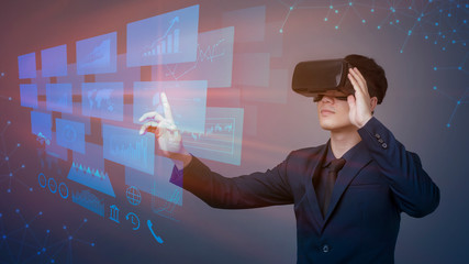Businessman working with futuristic virtual reality glasses. analytics on Digital screen with financial  graphs. Modern business concept.