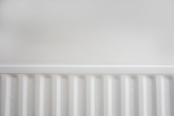 Close up of radiator against white wall modern new retro design.