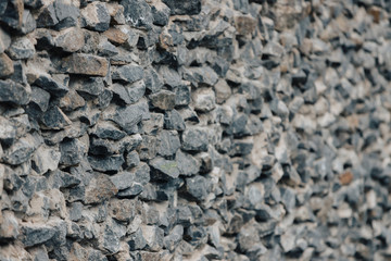 Stone wall. Detailed texture of a wall lined with cobblestones with cement.