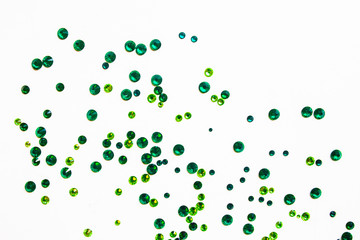 green rhinestones on a white background, top photo. design for text