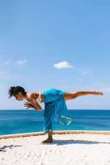 Virabhadrasana on the beach early morning near the sea