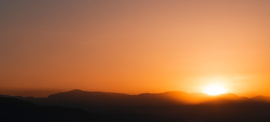 Beautiful bright sunrise sky over the mountains silhouette . Nature backgrounds