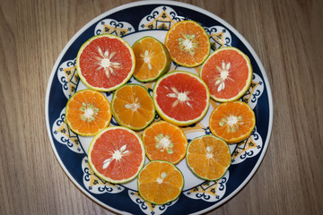 Beautiful lemons, bergamots and grapefruits cut in half on a cutting board.