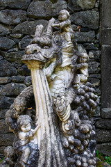 Obraz premium Buddhist sculpture of dragon. Botanical garden - Monte palace on sunny day. Oriental part of the garden. Madeira island, Portugal. September 2018.