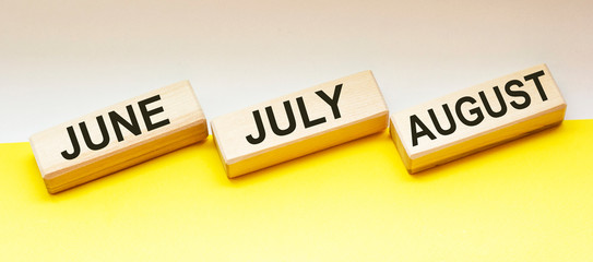 on wooden blocks text june july and august