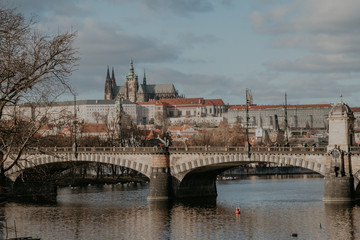 Fototapeta na wymiar sunny view of the old city of Prague and Vltava river