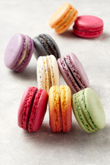 Colorful macaroons lying on the textural surface